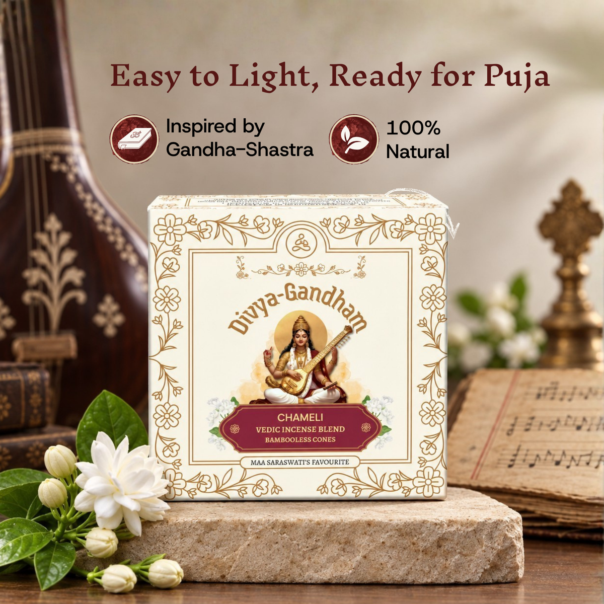 Divyagandham Chameli incense cones box highlighting it is easy to light, 100% natural, and inspired by Gandha-Shastra, placed near a Veena and jasmine flowers.