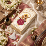 Overhead view of the Divyagandham Chameli bambooless incense sticks box featuring Maa Saraswati, surrounded by jasmine flowers, a lit brass diya, and an inkwell.