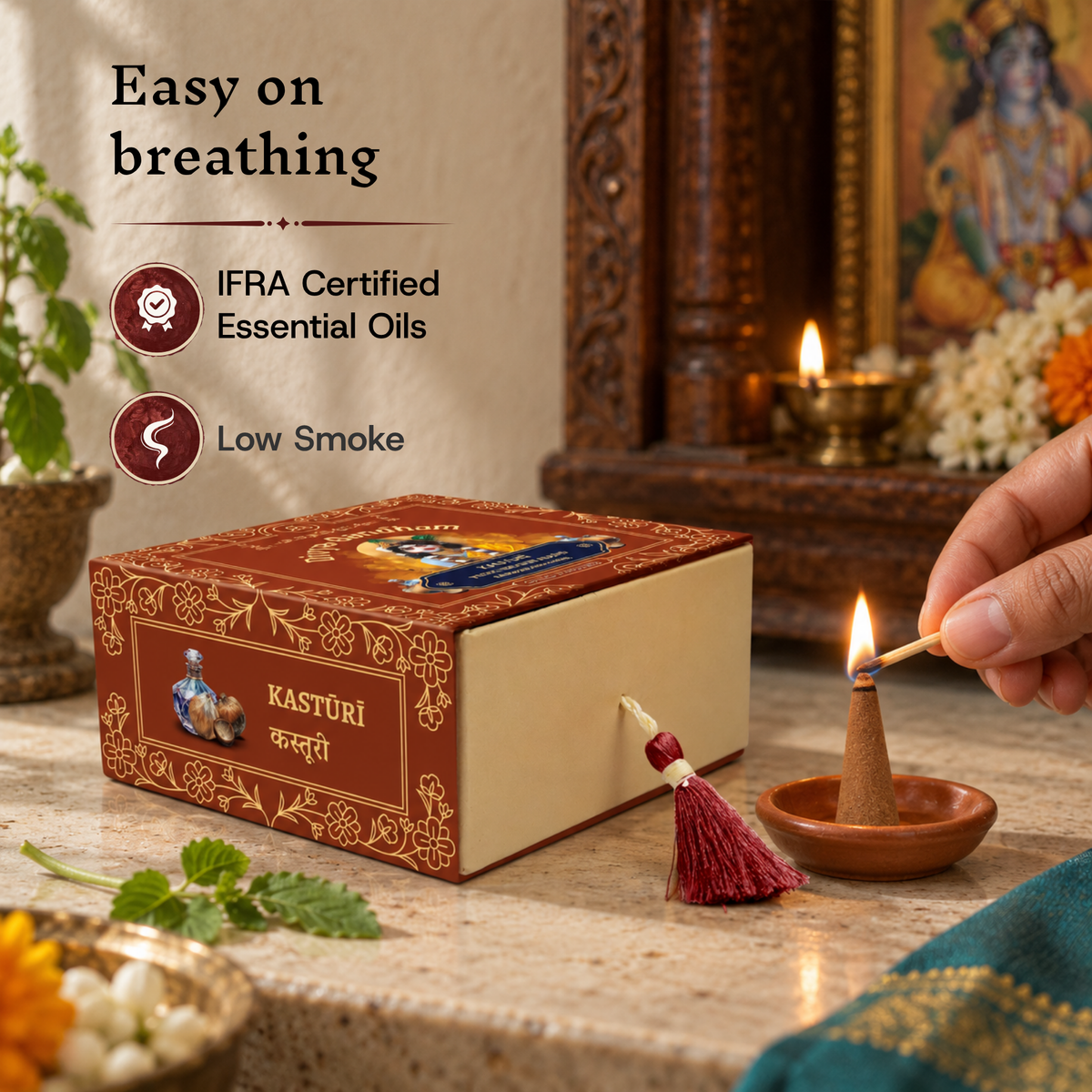Hand lighting a Divyagandham Kasturi incense cone highlighting easy breathing, IFRA certified essential oils, and low smoke, resting in front of the product box.