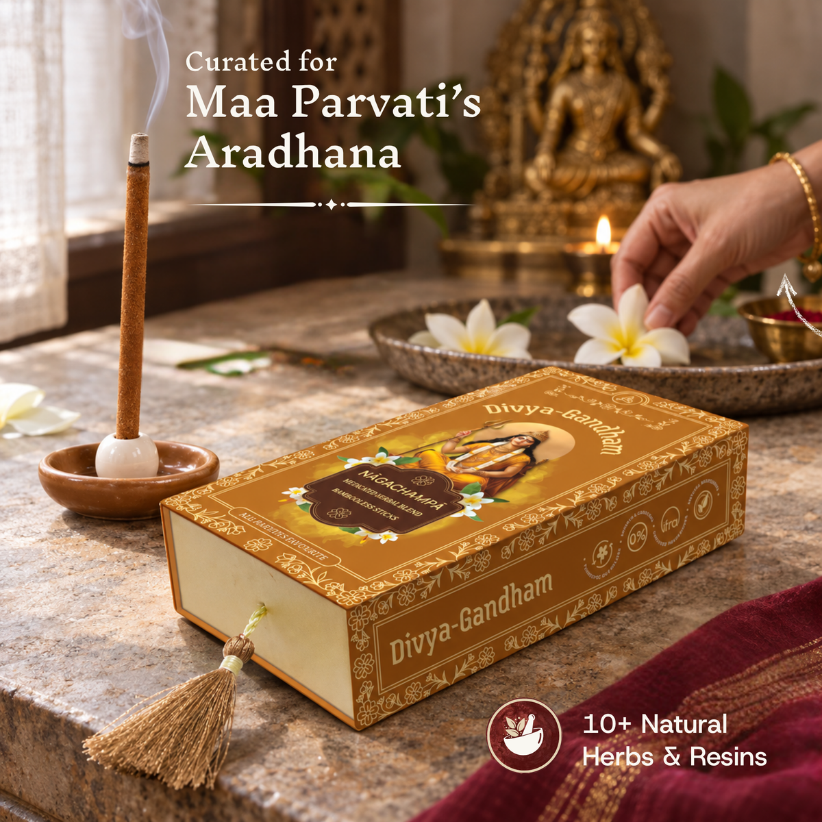Lit Divyagandham Nagachampa incense stick curated for Maa Parvati's Aradhana, featuring 10+ natural herbs and resins, positioned in front of the product box and a brass idol.