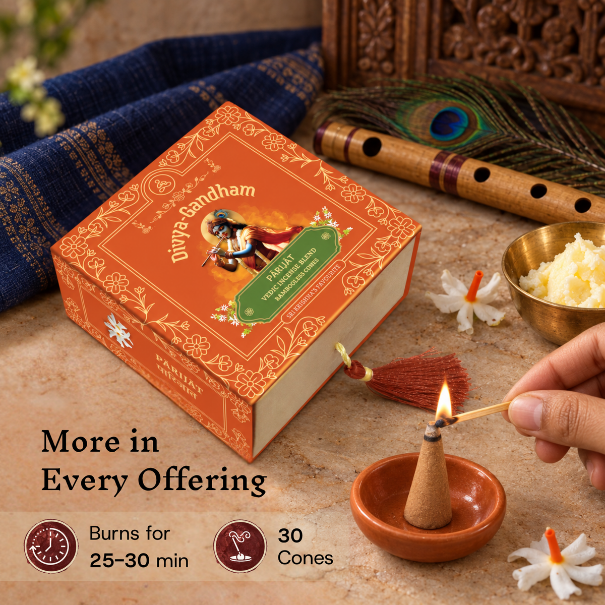 Hand lighting a Divyagandham Parijat incense cone, with the product box detailing a 30-cone count and a 25 to 30-minute burn time near fresh butter and parijat blossoms.