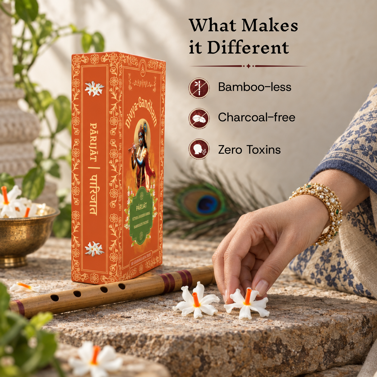 Upright Divyagandham Parijat incense sticks box emphasizing its bamboo-less, charcoal-free, and zero toxins qualities, with a hand placing a parijat flower near a wooden flute.