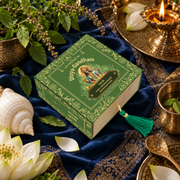 Overhead view of the Divyagandham Tulsi bambooless incense cones box featuring Lord Vishnu, surrounded by a white lotus, conch shell, and lit brass diya on a blue patterned cloth.